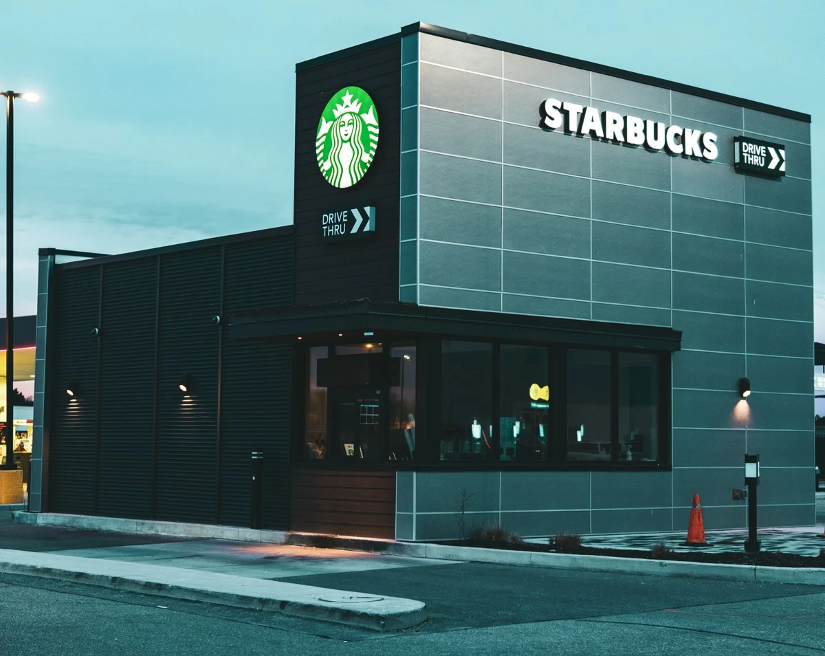 Coffee shop exterior with a drive-through service window and branded entrance
