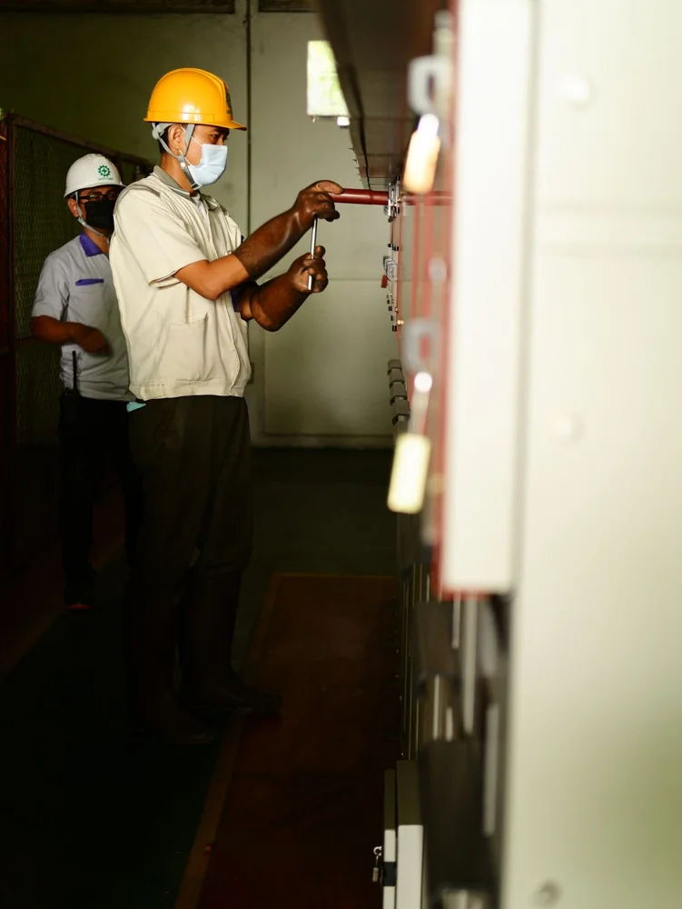 Commercial electrician working on electrical distribution equipment