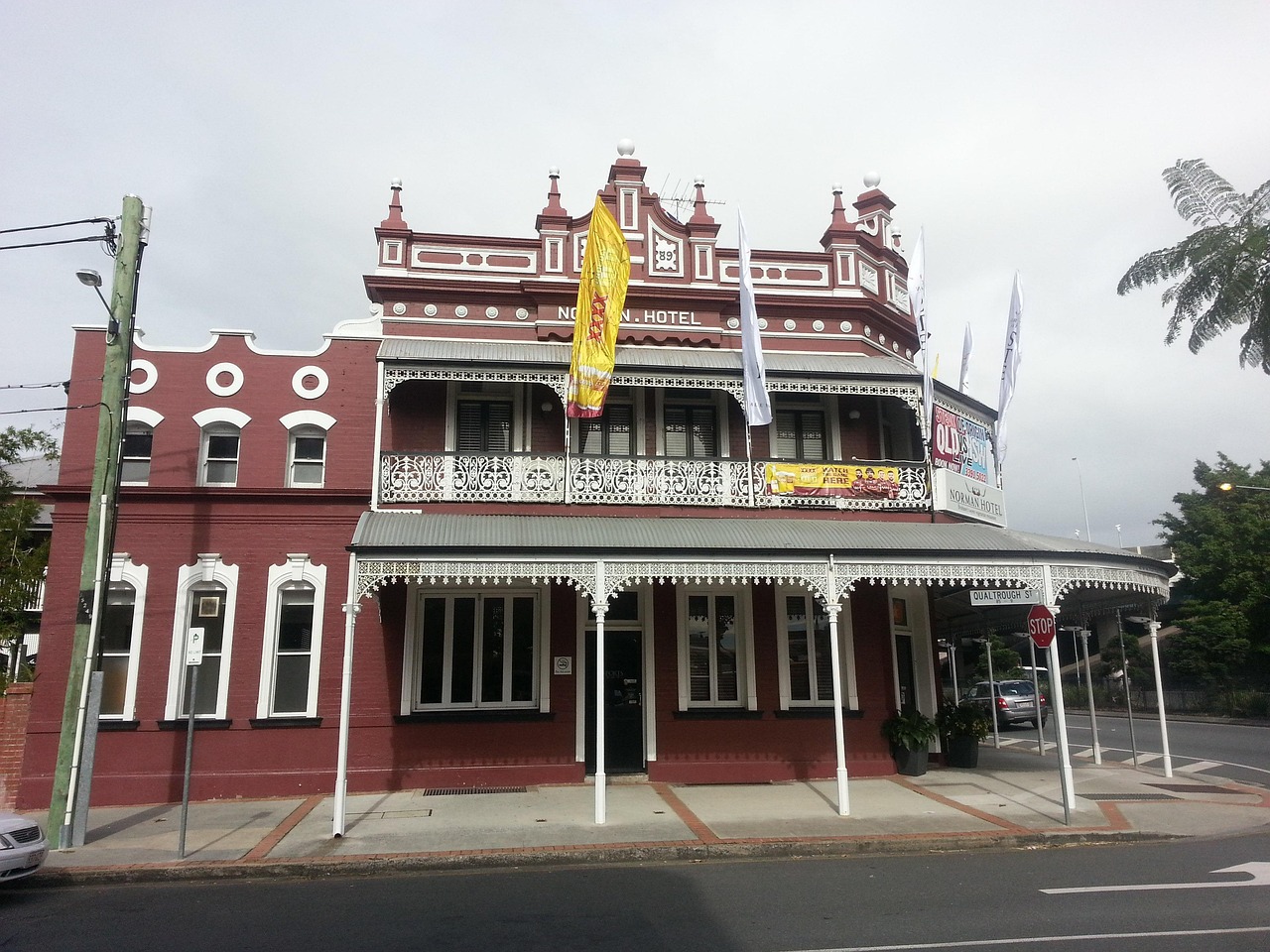 Hotel exterior with a covered entry and street-facing guest arrival